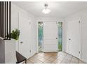 Bright foyer with tiled floors, leaded glass sidelights and white trim at 1118 Eagle Rd, Broomfield, CO 80020