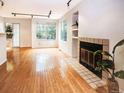 An airy living space featuring wood floors, fireplace, and natural light from the sliding glass door at 13894 E Lehigh Ave # G, Aurora, CO 80014