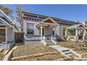 This single-Gathering home has a charming front porch, painted brick, and an inviting walkway at 1157 N Downing St, Denver, CO 80218