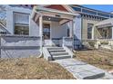 This home features painted brick, an inviting front porch, and well-defined steps at 1157 N Downing St, Denver, CO 80218