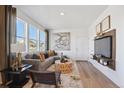 Cozy living room featuring a gray sofa and large windows at 934 Andrews Crest Dr, Berthoud, CO 80513