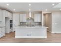 Modern kitchen with white cabinets, quartz countertops, and stainless steel appliances at 3432 N Gold Bug Ct, Aurora, CO 80019