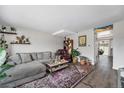 Comfortable living room with plush gray sectional, stylish rug, and curated decor, perfect for relaxation at 8666 Mariposa St, Thornton, CO 80260