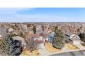 Expansive aerial view showcasing the residential neighborhood with lush trees and diverse home styles in a suburban setting at 16117 Ledge Rock Dr, Parker, CO 80134