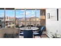 Cozy dining area with scenic views from large windows with seating for four at 955 Eudora St # 801E, Denver, CO 80220