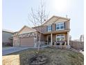 Charming two-story home with well-maintained lawn and inviting front porch at 3488 Purcell St, Brighton, CO 80601