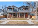 Charming two-story home featuring stone accents, a well-maintained lawn, and a welcoming front entrance at 4511 Meade St, Denver, CO 80211