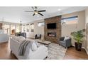 Inviting living room with a stone fireplace, hardwood floors, and large windows for ample natural light at 4511 Meade St, Denver, CO 80211