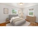Inviting bedroom with hardwood floors, neutral walls, and two windows offering a serene atmosphere at 1355 Rosemary St, Denver, CO 80220