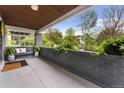 Inviting front porch with a comfortable bench, stylish decor, and a view of the serene surroundings at 3341 Newton St, Denver, CO 80211