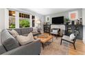 Cozy living room with a comfortable sofa, large windows, fireplace, and neutral decor at 3341 Newton St, Denver, CO 80211