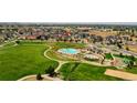 Aerial view showcasing community pool, playground, and expansive green space at 17186 E Cedar Gulch Dr, Parker, CO 80134