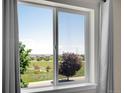 Picturesque window view overlooking a lush green park and neighborhood at 17186 E Cedar Gulch Dr, Parker, CO 80134