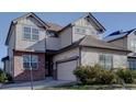 Attractive two-story house with neutral siding, brick accents, and an attached two-car garage at 1710 S Poplar St, Denver, CO 80224