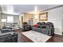 Spacious living room with dark hardwood floors and comfy seating at 2391 Lansing St, Aurora, CO 80010