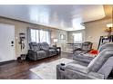 Living room with hardwood floors, recessed lighting, and gray sofas at 2391 Lansing St, Aurora, CO 80010