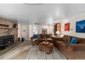 Cozy living room with a wood-burning fireplace, comfortable seating, and a warm, inviting atmosphere at 4295 Picutis Rd, Indian Hills, CO 80454