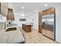 This modern kitchen features stainless steel appliances, an island with seating, and an open layout at 8095 Johnson Ct, Arvada, CO 80005