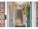 View of an entryway featuring a stairway with carpeted steps, a tiled floor, and a decorative green front door at 1630 Egret Way, Superior, CO 80027