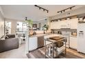 Bright, open kitchen featuring modern appliances, granite countertops, and a stainless steel kitchen island at 1630 Egret Way, Superior, CO 80027
