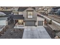 Attractive gray home showcasing a two-car garage, xeriscape landscaping, and welcoming entry at 4950 Saddle Iron Rd, Castle Rock, CO 80104