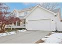 White two-story house with attached garage and landscaping at 1411 Maple Dr, Berthoud, CO 80513