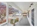 Covered porch with white railings and a swing, offering curb appeal at 1411 Maple Dr, Berthoud, CO 80513