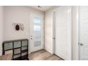 Welcoming entryway with storage shelves, coat hooks, and a bright front door with frosted windows at 2641 Channel Dr, Highlands Ranch, CO 80129