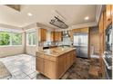Spacious kitchen with an oversized center island, modern stainless steel appliances, and tile flooring at 209 Saratoga Mine Dr, Castle Rock, CO 80108