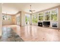 Bright living room featuring large windows, hardwood floors, and a cozy fireplace at 209 Saratoga Mine Dr, Castle Rock, CO 80108