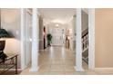 Spacious foyer featuring tile flooring, white pillars, and a view of the front door at 6023 E Briarwood Dr, Centennial, CO 80112