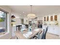 Open-concept kitchen and dining area with stainless steel appliances and plenty of cabinet space at 10886 Pheasant Run, Littleton, CO 80125