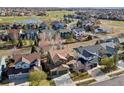 Panoramic aerial view of a residential neighborhood showcasing manicured lawns, mature trees, and nearby golf course at 1788 Alpine Dr, Erie, CO 80516