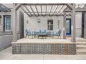 Inviting home exterior with a covered porch, seating, and a charming brick facade at 1819 W 32Nd Ave, Denver, CO 80211