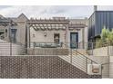 Inviting home exterior with a covered porch, seating, and a charming brick facade at 1819 W 32Nd Ave, Denver, CO 80211
