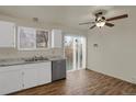 Bright kitchen featuring stainless steel appliances, marble countertops, and a sliding glass door at 16651 E Arizona Pl, Aurora, CO 80017