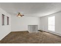 Living room featuring a ceiling fan and loft view at 16651 E Arizona Pl, Aurora, CO 80017