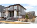 Stylish two-story home showcasing a well-manicured yard and modern architectural details at 9976 E 63Rd Ave, Denver, CO 80238