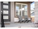 Inviting front porch area, complete with seating for relaxing outdoors at 9976 E 63Rd Ave, Denver, CO 80238