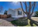 View of the side of the home with lawn, landscaping and partial shade at 5160 Hannibal St, Denver, CO 80239