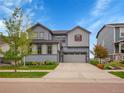 Charming two-story home with a well-manicured lawn, attached two car garage, and beautiful landscaping at 7012 S Undergrove Way, Aurora, CO 80016