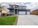 Beautiful two-story home featuring a two car garage, landscaped yard and a charming covered front porch at 8374 E 132Nd Pl, Thornton, CO 80602