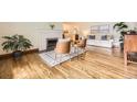 Bright living room featuring hardwood floors, fireplace, and stylish furnishings at 5475 W Ottawa Ave, Littleton, CO 80128