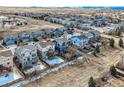Aerial view highlighting neighborhood with rear fenced yards, trees, and house elevations at 5657 Jaguar Way, Lone Tree, CO 80124