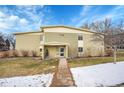 Two-story building with yellow siding and well-maintained front yard at 710 S Clinton St # 6A, Denver, CO 80247