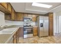Well-equipped kitchen with stainless steel appliances, wooden cabinets, and laminate countertops, offering a practical cooking space at 14001 E Marina Dr # 606, Aurora, CO 80014