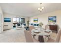 Inviting living room with a dining space showcases a marble table, comfortable seating, and artwork, creating an elegant atmosphere at 14001 E Marina Dr # 606, Aurora, CO 80014
