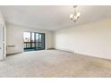 Spacious living room features a large window and balcony access, offering plenty of natural light and a comfortable living space at 14001 E Marina Dr # 606, Aurora, CO 80014