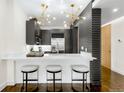 Modern kitchen with stainless steel appliances, white marble countertops, and stylish bar stool seating at 333 S Monroe St # 211, Denver, CO 80209