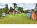 Large backyard featuring mature trees and storage sheds, offering plenty of space and utility at 8840 Niwot Rd, Niwot, CO 80503